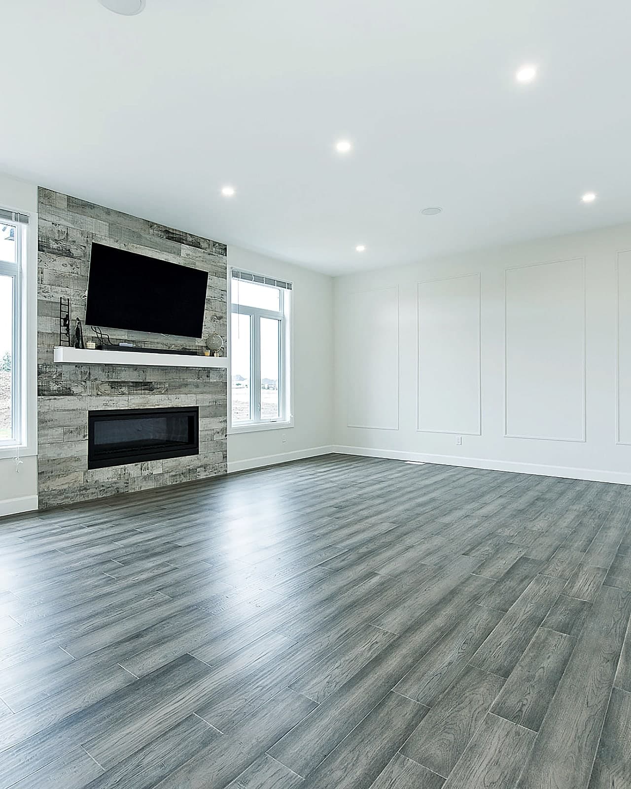 Bright, open great room with a wall of windows in a Black Cedar custom home