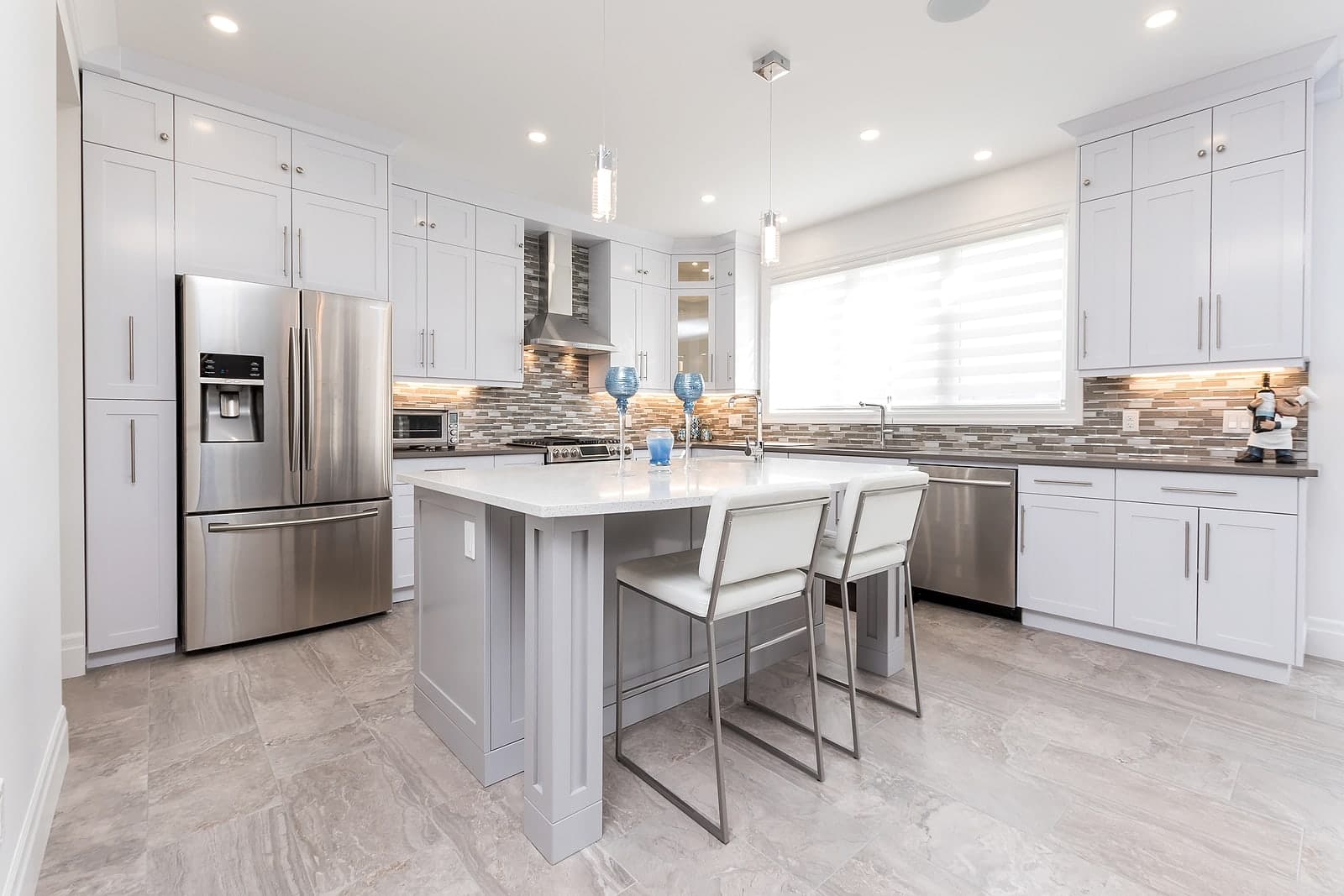White kitchen with quartz island at Foxwood Crossings, London Ontario