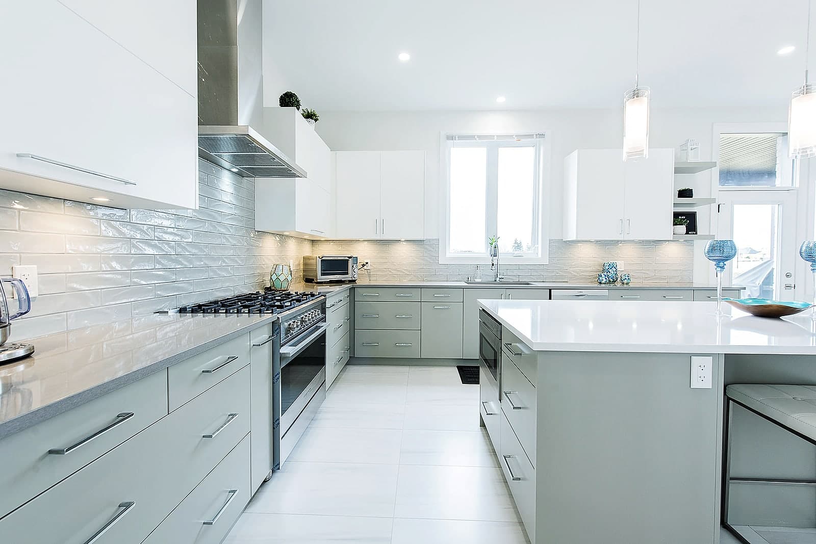 Kitchen with a quartz island open to the dining area in a Black Cedar custom home