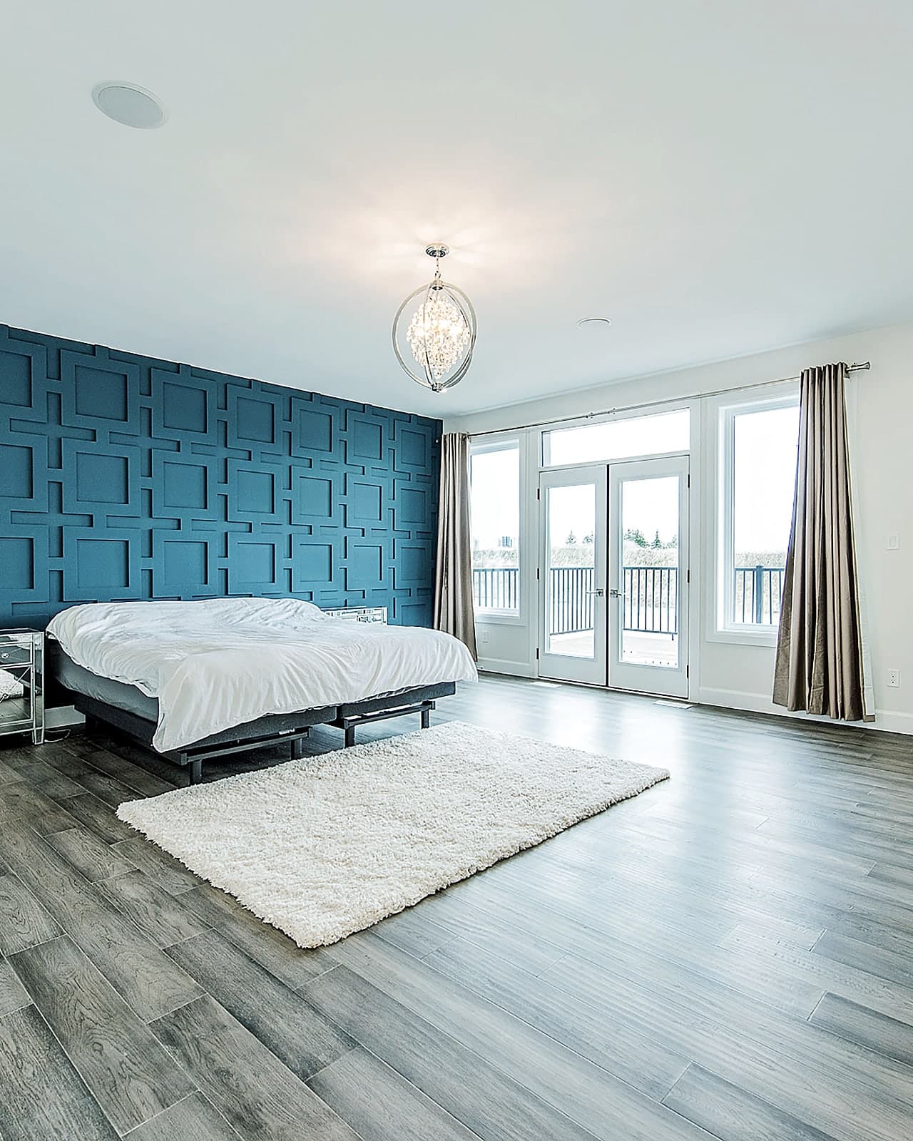 Primary bedroom with a blue feature wall opening to the ensuite