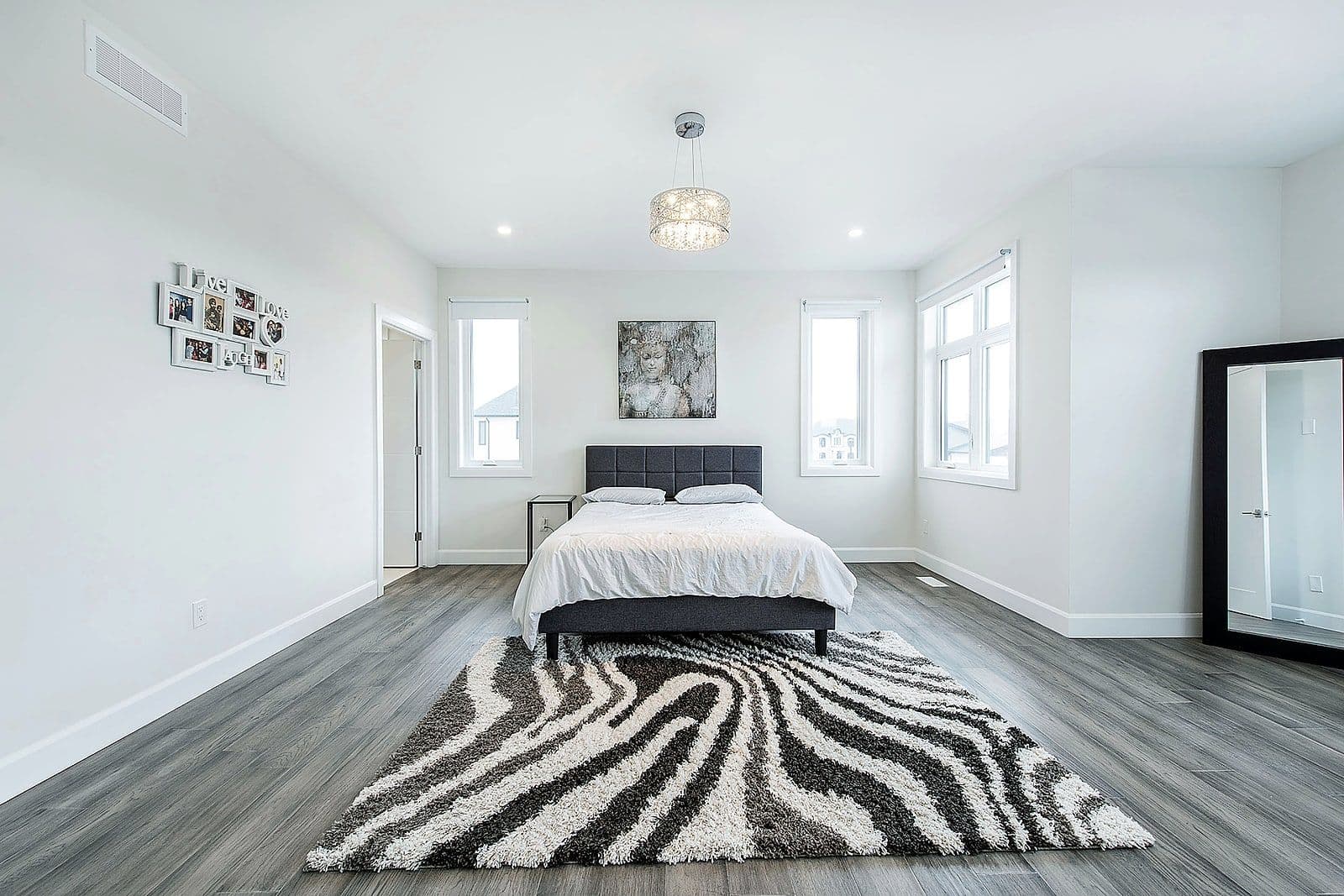 Bedroom with hardwood floors and bright windows