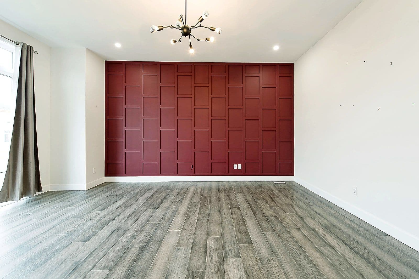 Dining room with a deep red feature wall