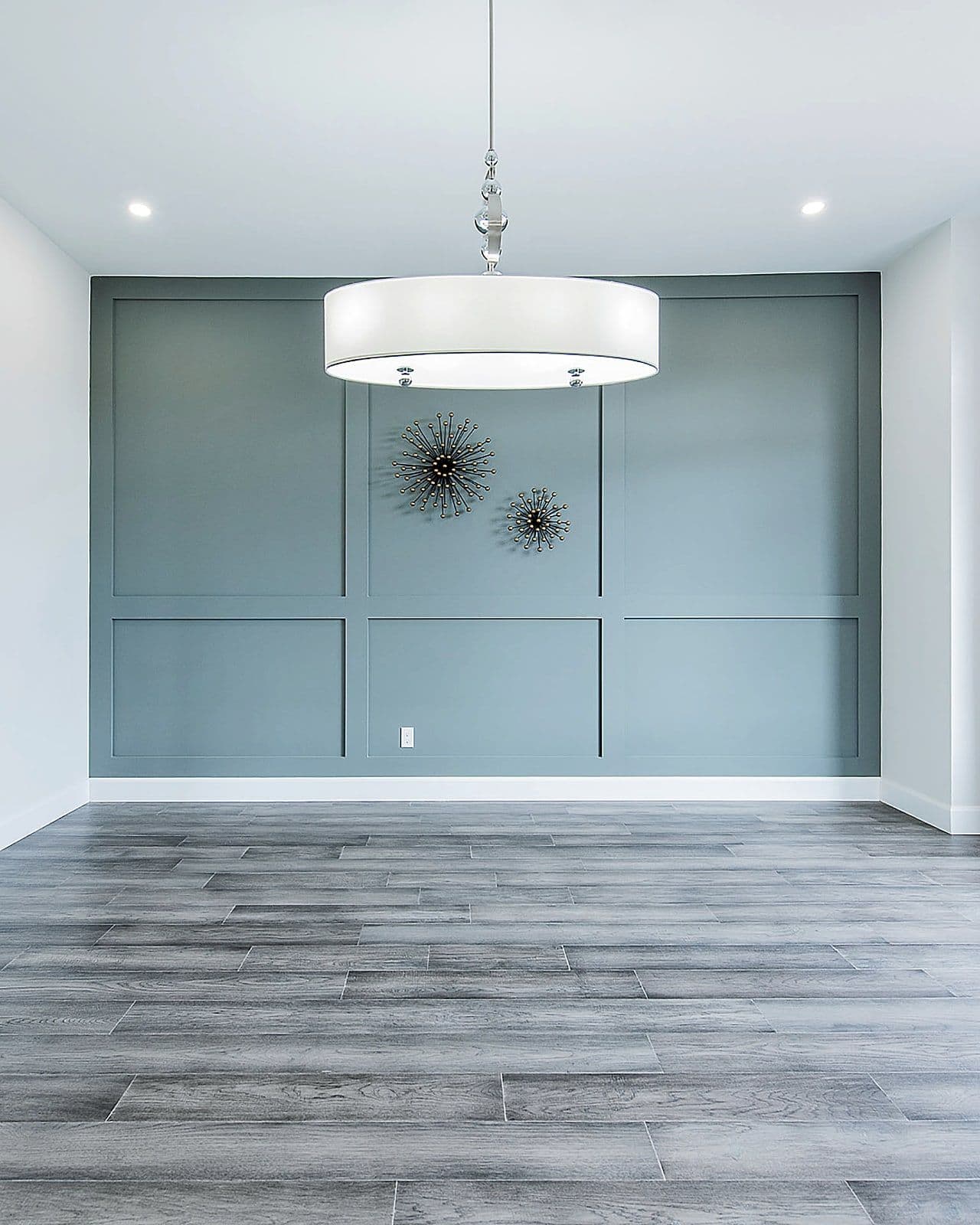 Dining room with a panelled feature wall in the Silverleaf show home