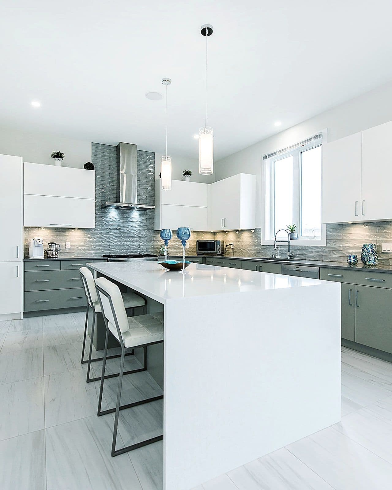 Kitchen with a large quartz island in the Silverleaf show home