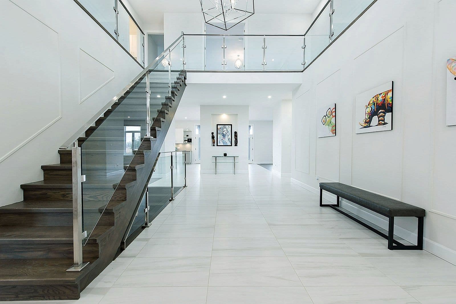 Open-riser staircase with a glass railing in the Silverleaf home