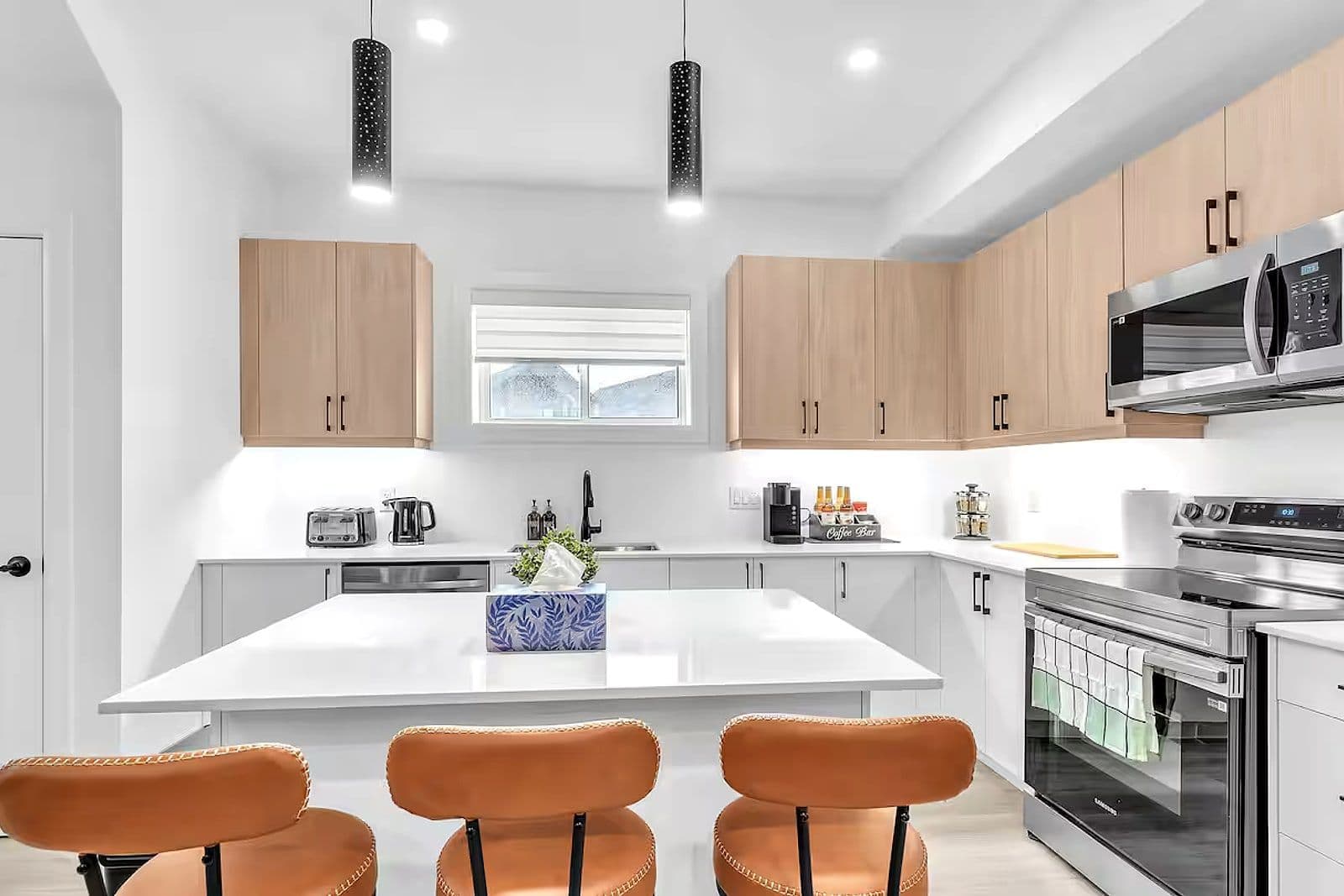 Kitchen island with bar stools in the lower-level unit