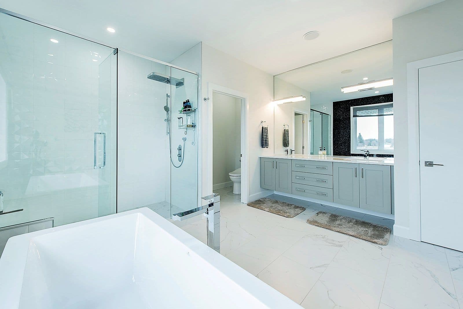 Ensuite with a freestanding tub, glass shower and double vanity