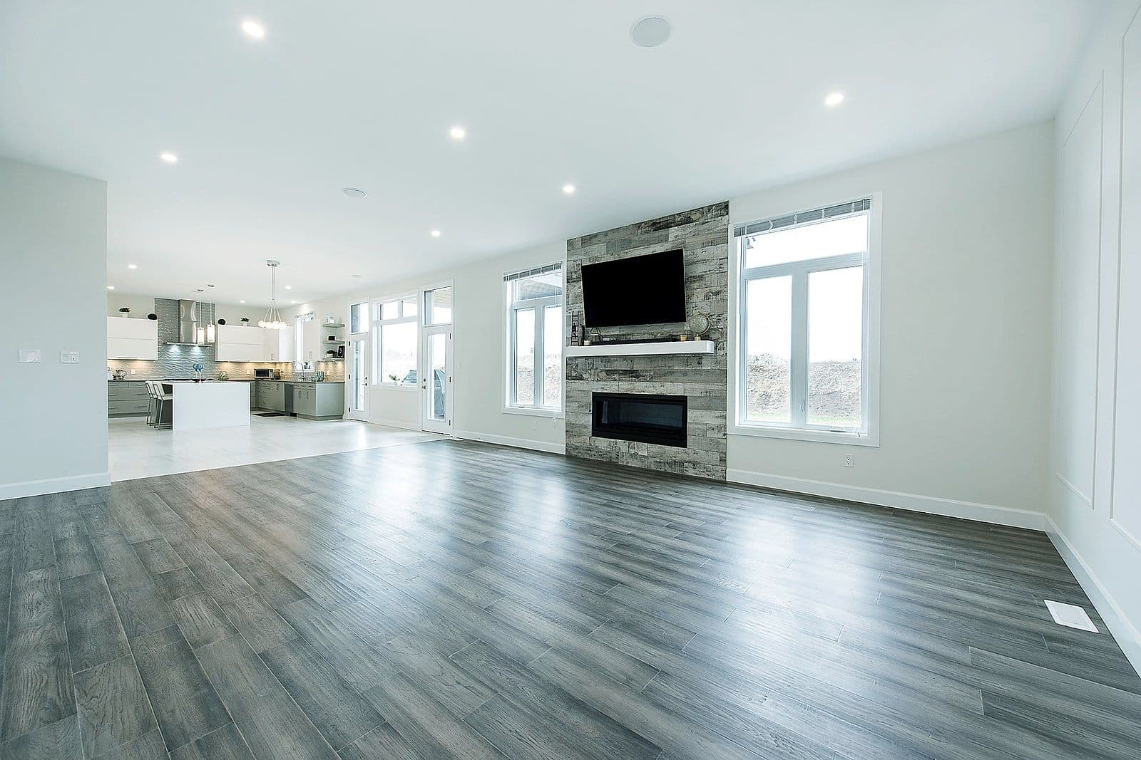 Living room with a stone fireplace and mounted television