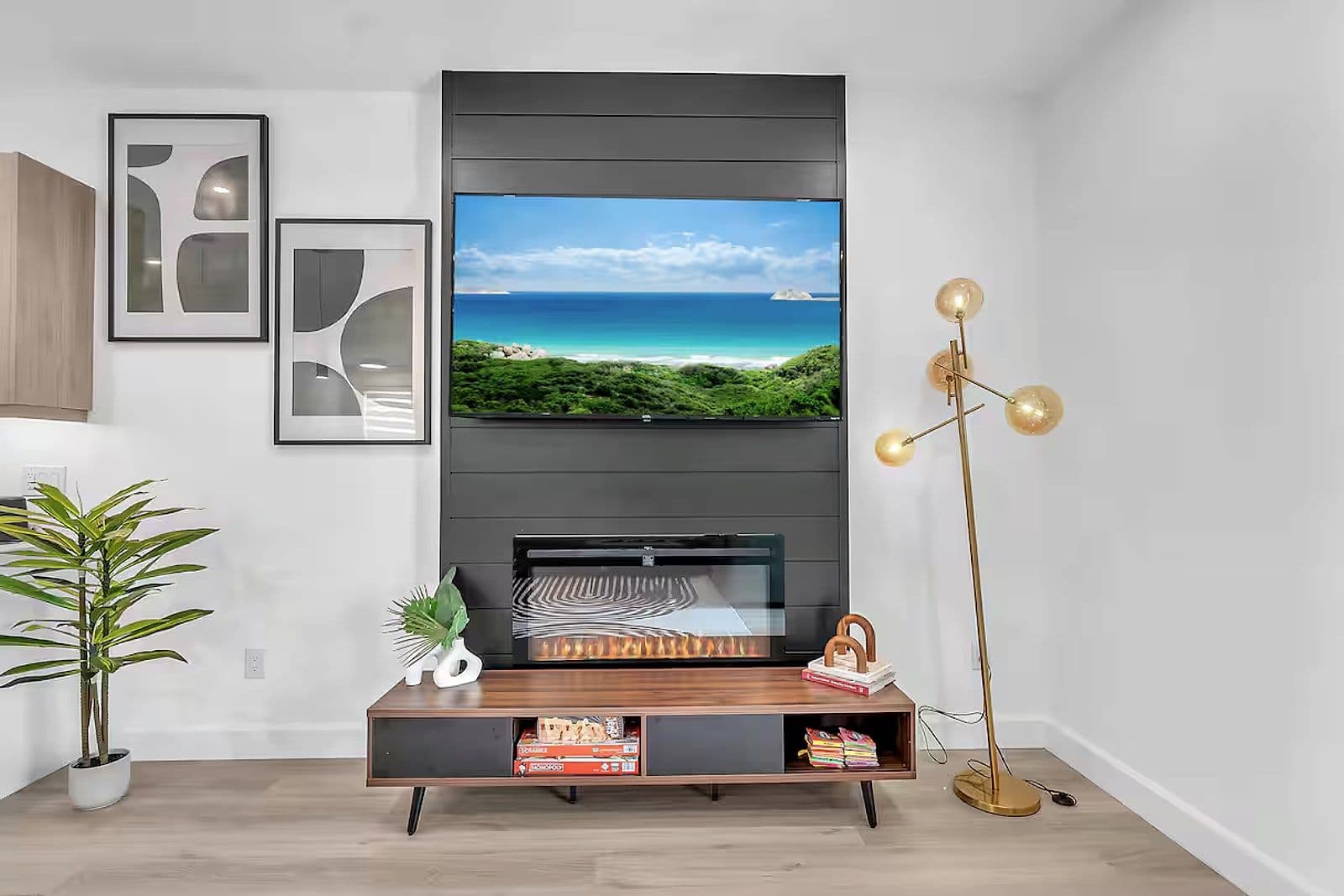 Living room with a linear fireplace and mounted television