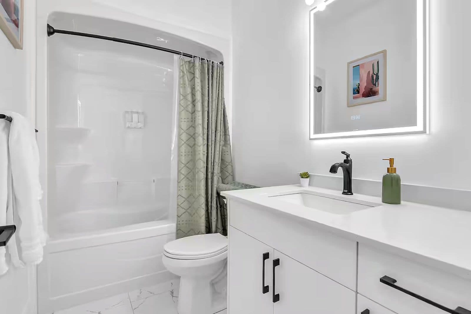 Bathroom with a tub-shower and a floating vanity