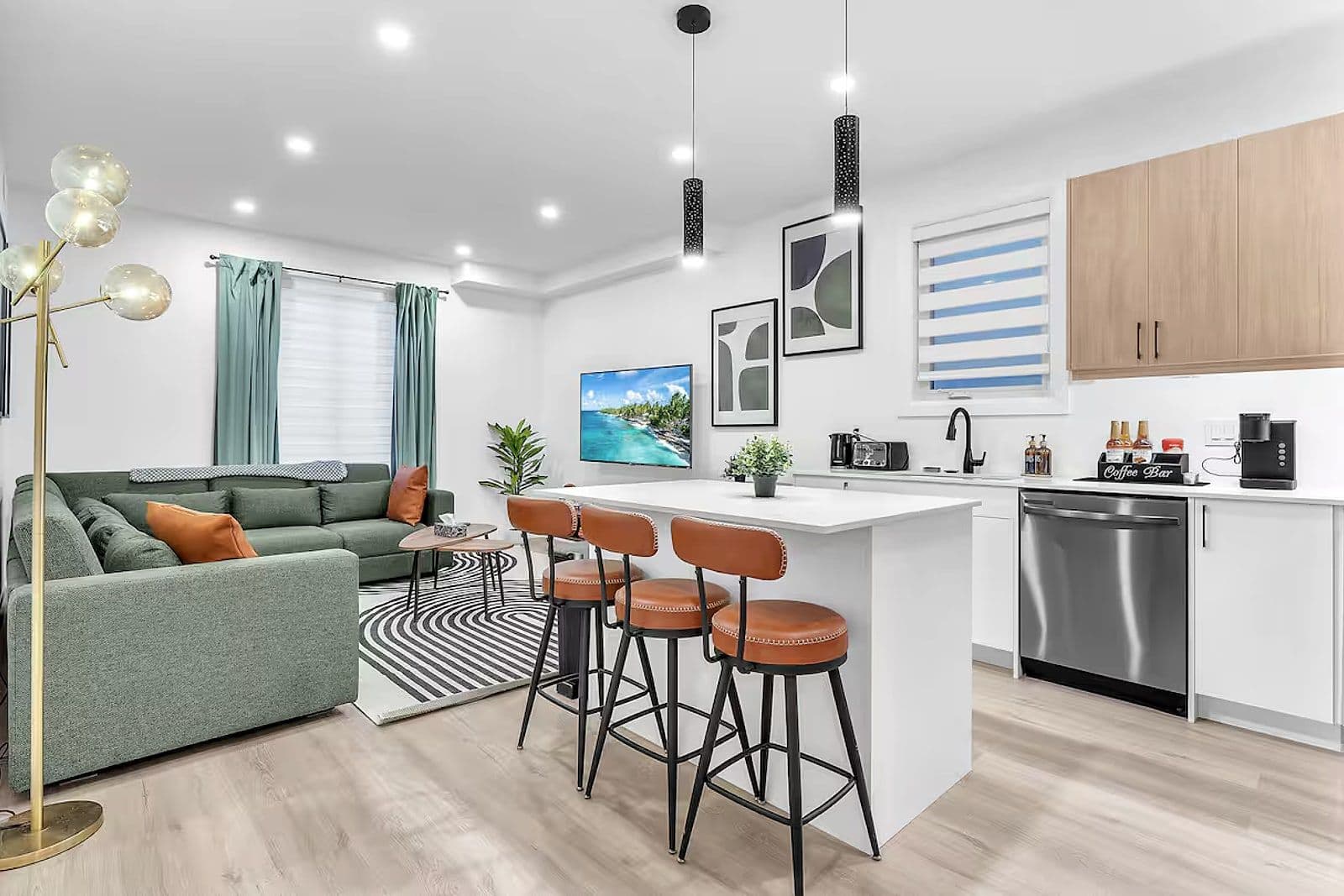 Kitchen with a waterfall island and bar seating in a Lambeth triplex unit