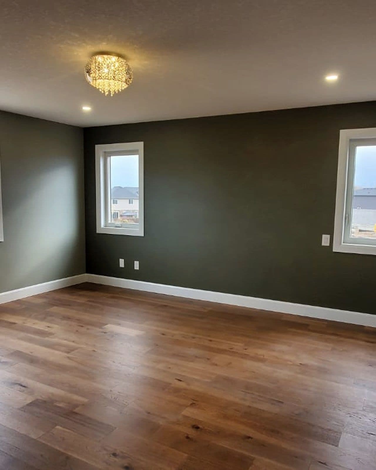 Bright bedroom with hardwood floors in a Canvas home