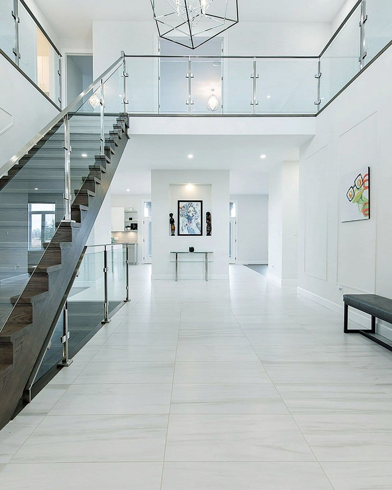 Open-riser staircase with glass railings in the Silverleaf show home